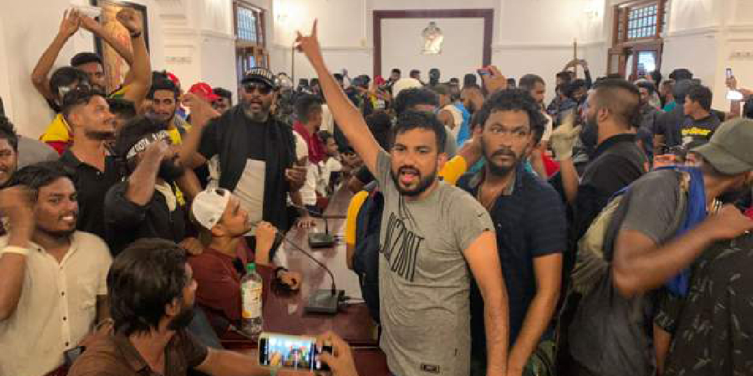 Protesters storm Sri Lanka’s prime minister’s office, as president flees country without resigning