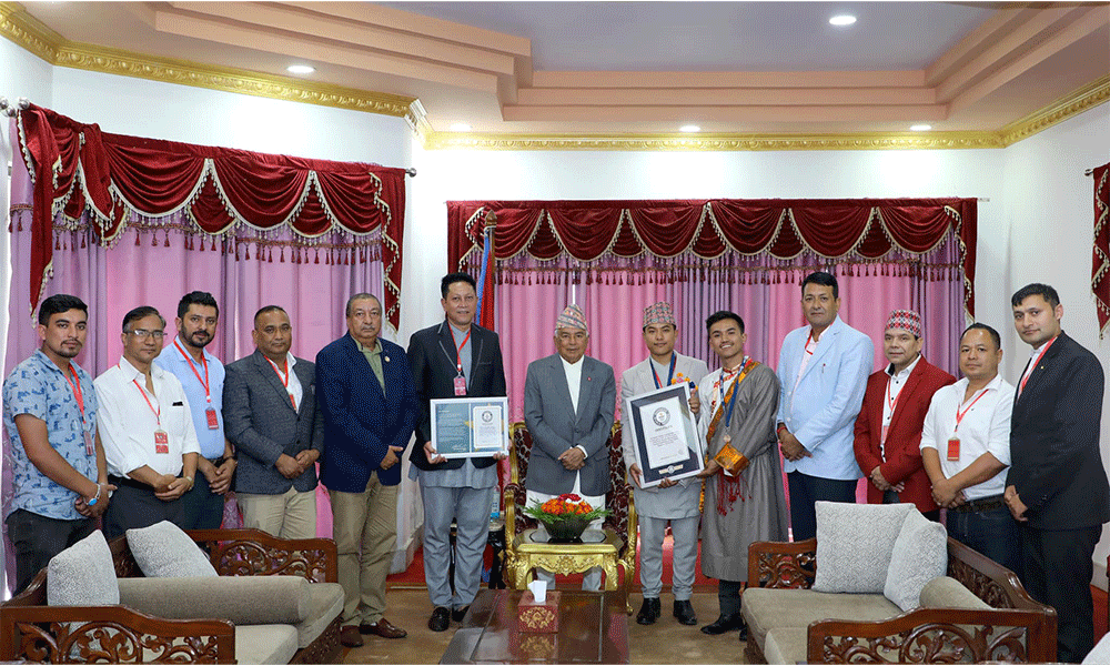 President Poudel presents Guinness World Record certificate to Surendra Rai and Susan Tamang